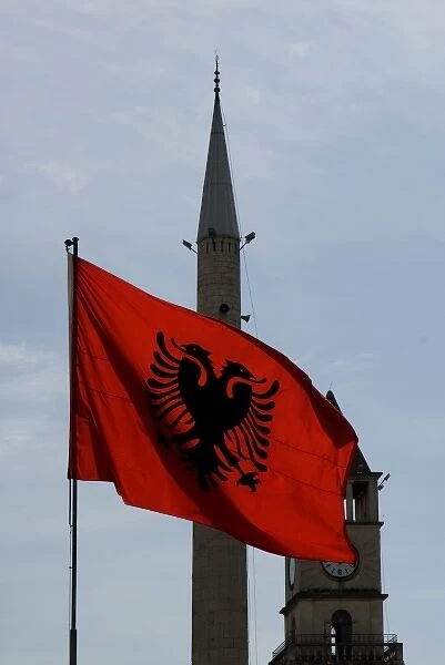 Albania, Tirana, Albanian flag in Skanderbeg square, minaret and bell tower