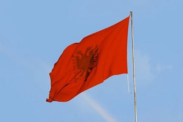 The Albanian flag banner, red with a black double headed eagle. The Tirana Main Central Square
