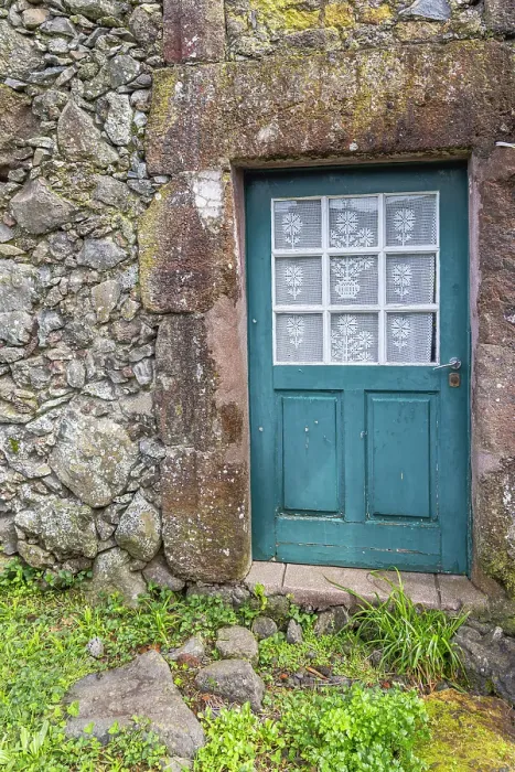 Framed Print : Aldeia da Cuada, Flores, Azores, Portugal. Blue door on a stone building