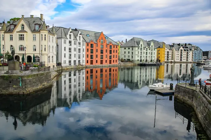 Framed Print : Alesund, Norway. Canal with colorful painted houses, boats, marina, sailor statue Framed Print : Alesund, Norway. Canal with colorful painted houses, boats, marina, sailor statue