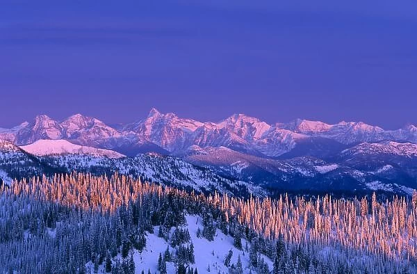 Alpenglow strikes the peaks of Glacier National Park from the summit of Big Mountain