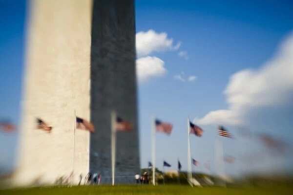 American flags next to Washington Monument (blurred), Washington D. C. (District of Columbia)