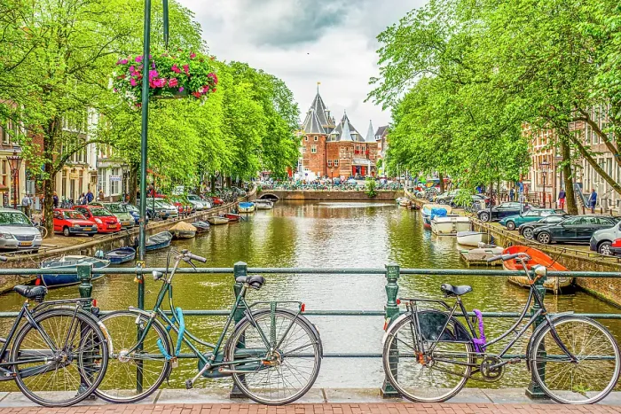 Framed Print : Amsterdam, Netherlands. Wide angle landscape view of bicycles chained to a bridge overlooking a canal