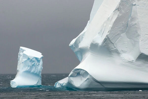 Antarctica. Antarctic Peninsula. Bransfield Strait. Iceberg under stormy skies