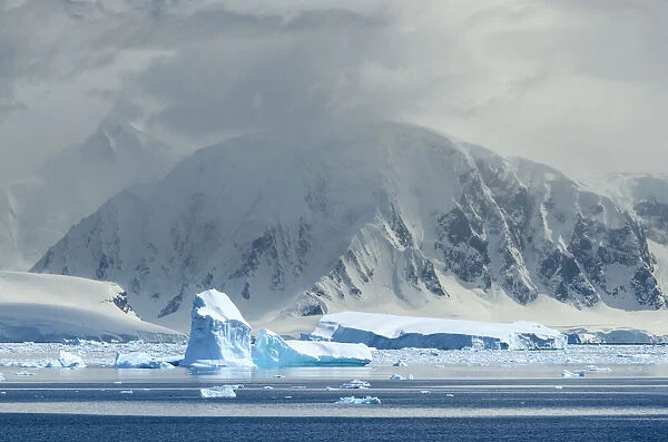 Antarctica, Antarctic Peninsula, Andvord Bay. Iceberg and mountain landscape