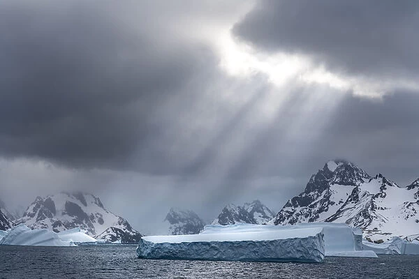 Antarctica, South Georgia Island. Sunbeams light up icebergs