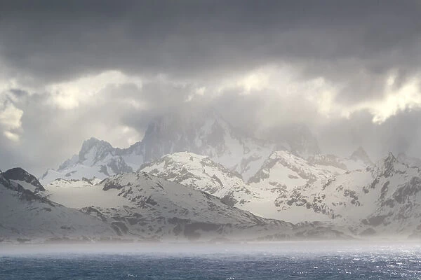 Antarctica, South Georgia Island, Coopers Bay. Storm clouds over mountains