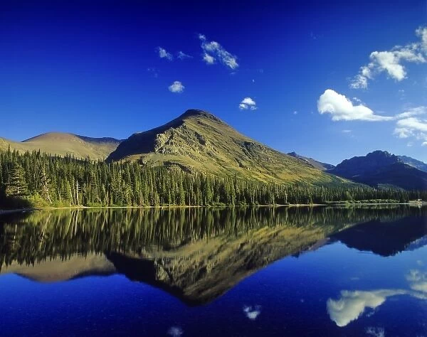 Appistoki Peak reflects into Pray Lake in the Two Medicine Valley of Glacier National Park