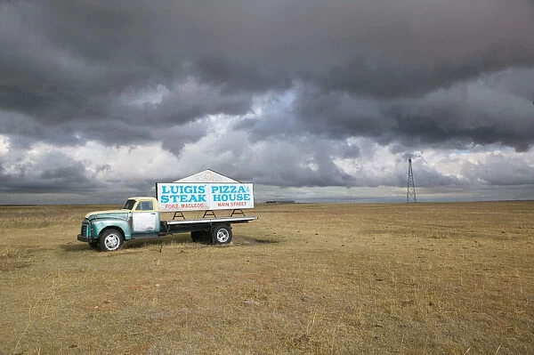 02. Canada, Alberta, Fort MacLeod: Approaching Storm & Truck Sign for Luigis Pizza