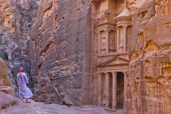Arab man watching Facade of Treasury (Al Khazneh), Petra, Jordan (UNESCO World Heritage