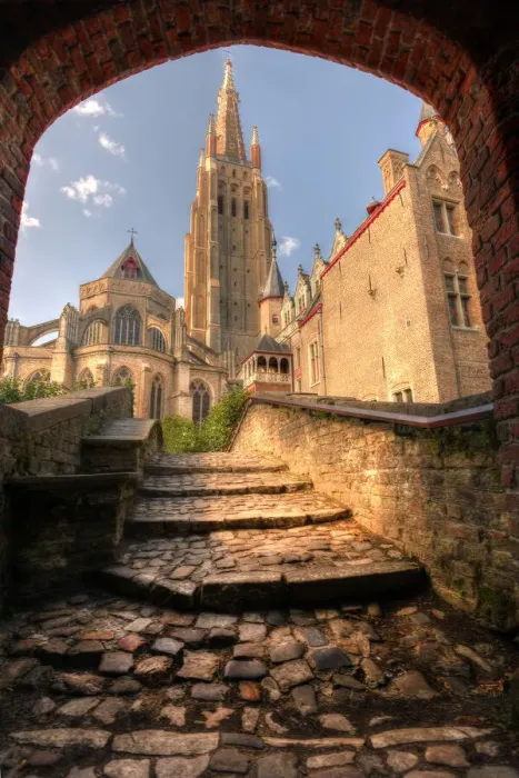 Framed Print : An arch leads to a church in Bruges, Belgium Framed Print : An arch leads to a church in Bruges, Belgium