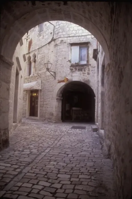 Framed Print : An arched cobbled walkway leads to many residential areas in the central part of Trogir Framed Print : An arched cobbled walkway leads to many residential areas in the central part of Trogir