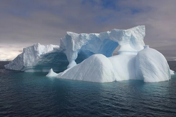 arched iceberg floating off the western Antarctic peninsula, Antarctica, Southern Ocean