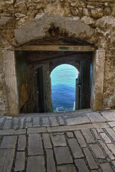 Arched walkway framing view of Adriatic Sea, Rovigno, Croatia