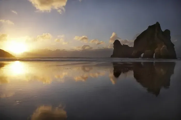 Framed Print : Archway Islands Reflected in Wet Sands of Wharariki Beach at Sunset, near Cape Farewell