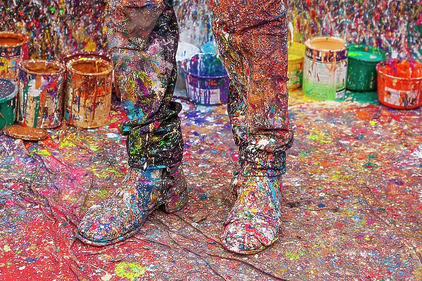 Argentina, Buenos Aires. Colorful paint spatters on artist's boots