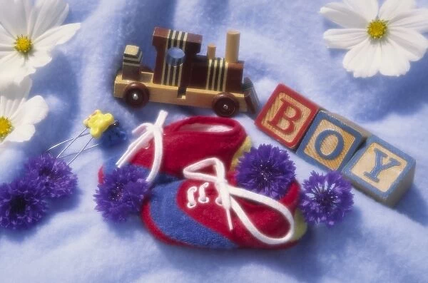 Arrangement of baby boy items on blue blanket