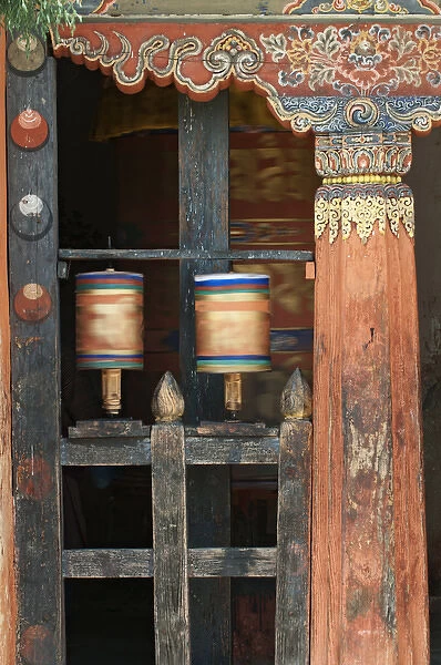 Asia, Bhutan, Bumthang. Prayer wheels spinning in Jampey Lhakhang temple. Credit as