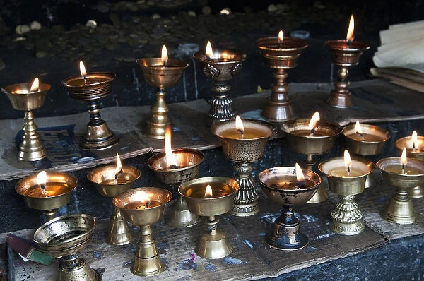 Asia, Bhutan, Dochu La. Yak butter candles burn in shrine