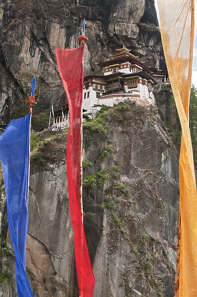 Asia, Bhutan. Prayer flags hang near Taktshang or Tigers Nest, the most famous monastery in Bhutan