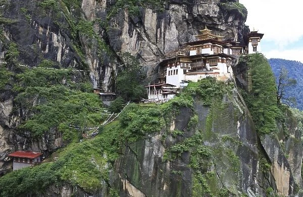Asia, Bhutan. Taksang Dzong monastery is built into the rock and hangs on a precipitous