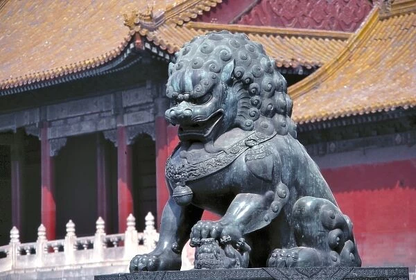 Asia, China, Beijing. A statue of a powerfully-built lion guards the Forbidden City
