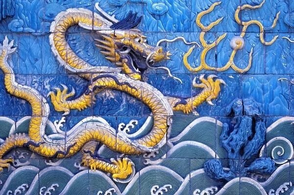 Asia, China, Beijing. Stylized dragons nearly jump from this tiled wall, in the Forbidden City