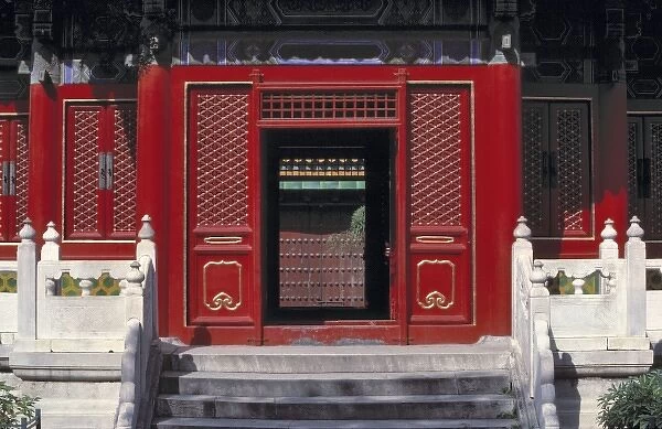 Asia, China, Beijing. White balastrades contrast with this striking red lacquer door