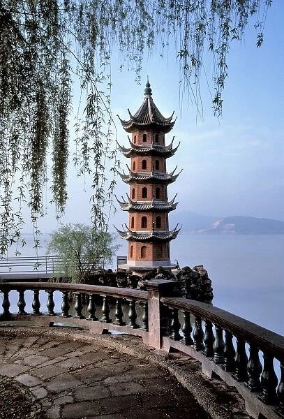 Asia, China, Wuxi. Willow branches frame a miniature pagoda on Lake Tai in Wuxi in China