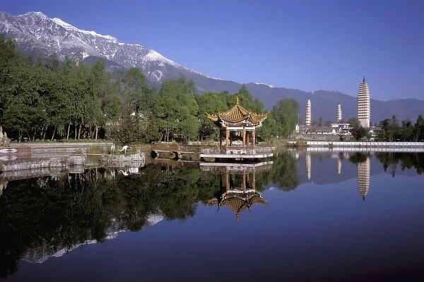 Asia, China, Yunnan Province, Dali. Three Pagodas and pavilion reflect in small lake