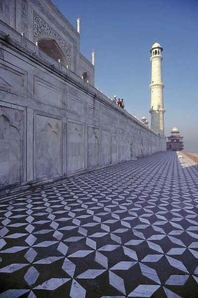 Asia, India, Agra. A marble walkway leads to a minaret at the Taj Mahal, a World Heritage Site