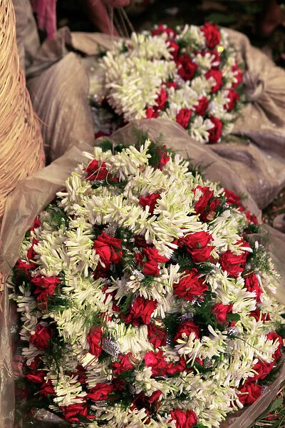 Asia, India, Calcutta. Garlands of rose and freesia in the flower market in Calcutta