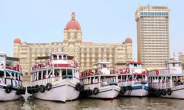 Asia, India, Maharashtra, Mumbai. The Taj Mahal Hotel in Mumbai and boats docked in the marina