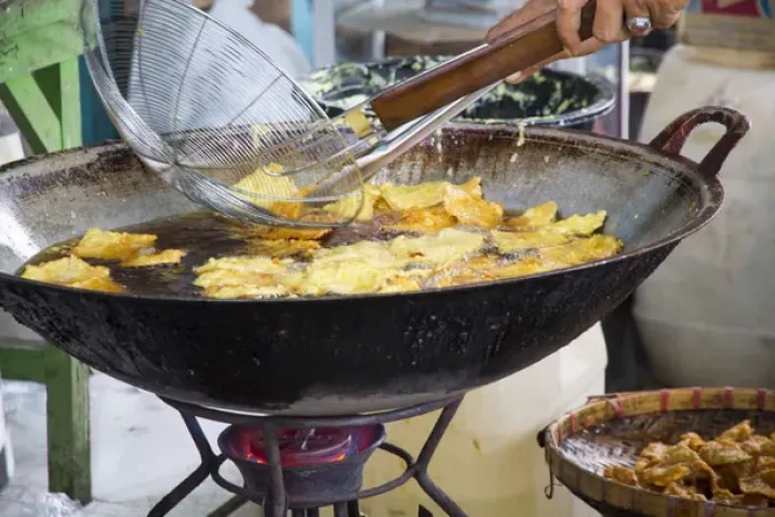 Framed Print : Asia, Indonesia, Bali. Frying Indonesian food called bali bakwan and tofu goreng