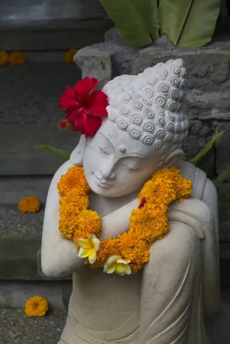 Framed Print : Asia, Indonesia, Bali. Sacred statue with red Hybiscus flower and yellow Marigold necklace