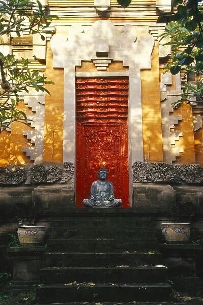 Asia, Indonesia, Bali, Ubud. Buddha statue in front of Balinese Hindu temple