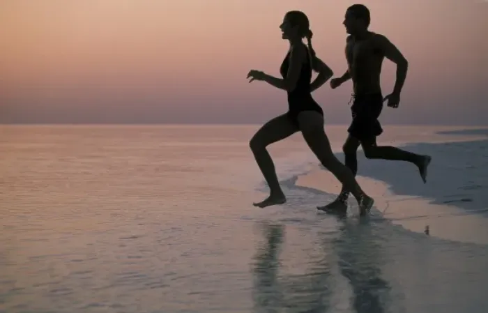 Framed Print : Asia, Maldives. Couple running on beach (MR)