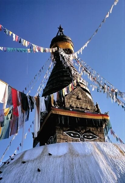 Asia, Nepal, Kathmandu Valley. Dawn lights the face of Swayambunath and the prayer