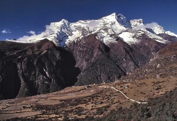 Asia, Nepal, Sagarmatha NP. Kwangde Peak, at 19, 721 feet, looks down on the village
