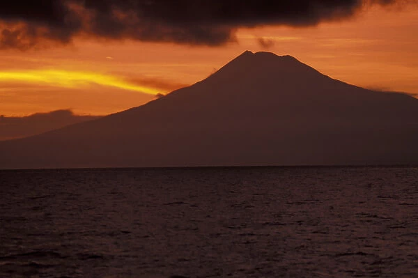 Asia, Papua New Guinea, Kimbe Bay. Volcano at sunset
