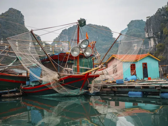 Framed Print : Asia, Vietnam, Quang Ninh, Ha Long Bay. Colorful fishing boat at its dock is reflected Framed Print : Asia, Vietnam, Quang Ninh, Ha Long Bay. Colorful fishing boat at its dock is reflected