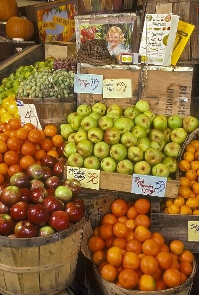 Assortment of apples and oranges in old fashion style display at grocery store. North America