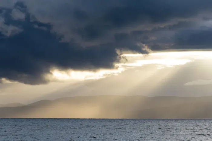 Framed Print : Australia, Tasmania, Freycinet National Park Morning light breaks through dark clouds