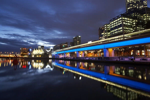 Australia, Victoria, Melbourne, Buildings and Blue Lighting on Railway Bridge Reflected