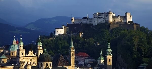 Austria, Salzburg. Sunset view of Hohensalzburg Fortress on hilltop overlooking Old Town of city
