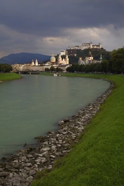 Austria, Salzburg. View along the Salzach River across city to Hohensalzburg Fortress on hilltop