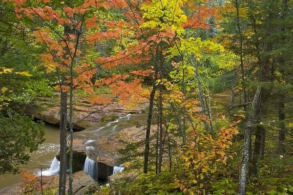 Autumn maple trees frame O Kun De Kun Falls on the Baltimore River in the Ottawa