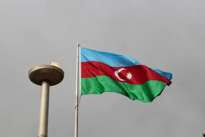 Framed Print : Azerbaijan, Baku. An Azerbaijan flag waves near a memorial flame Framed Print : Azerbaijan, Baku. An Azerbaijan flag waves near a memorial flame