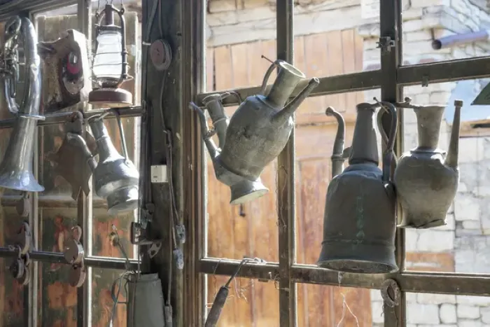 Framed Print : Azerbaijan, Lahic. Antique kettles hanging on the inside of a window
