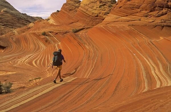 Backpacker at Coyote Buttes in the Paria Vermillion Cliffs Wilderness Area at the Utah